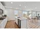 Bright, open-concept kitchen with an island, stainless steel appliances, and a view to the living room at 1397 Brookfield Pl, Erie, CO 80026