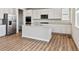Well-lit kitchen with a large island, stainless steel appliances, and light wood flooring at 1397 Brookfield Pl, Erie, CO 80026