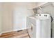 Convenient laundry room equipped with a washer, dryer, and overhead shelving at 1397 Brookfield Pl, Erie, CO 80026