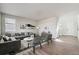 Bright living room with modern decor, gray sectional sofa, and wood-style flooring at 1397 Brookfield Pl, Erie, CO 80026