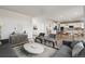 Bright open floor plan with a living room flowing into a modern kitchen and dining area at 1397 Brookfield Pl, Erie, CO 80026