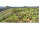 Aerial view of estate home on rolling hills with mature tree coverage at 393 Dixon Rd, Boulder, CO 80302