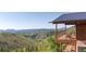 Relaxing balcony view of mountains and lush greenery from a covered porch at 393 Dixon Rd, Boulder, CO 80302