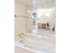 Bright bathroom featuring a tub with gold fixtures and a large mirror reflecting a vintage vanity at 393 Dixon Rd, Boulder, CO 80302