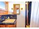 Quaint bathroom featuring blue tiled walls, a yellow sink, and wood accents, offering unique charm at 393 Dixon Rd, Boulder, CO 80302