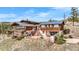 Multi-level home featuring wood siding, stone patio, and scenic mountain views at 393 Dixon Rd, Boulder, CO 80302