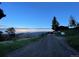 Scenic exterior view of home at dusk with mountainous backdrop and gravel driveway at 393 Dixon Rd, Boulder, CO 80302