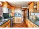 Well-equipped kitchen with custom cabinets, stainless steel appliances, and rustic tile flooring at 393 Dixon Rd, Boulder, CO 80302