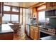 Well-lit kitchen with terracotta tile flooring, wooden cabinets, granite countertops, and a beautiful view at 393 Dixon Rd, Boulder, CO 80302