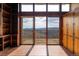 Bright living room boasting a wall of windows showcasing mountain views and an outdoor deck at 393 Dixon Rd, Boulder, CO 80302