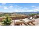 Charming patio with lounge chairs, and a stunning view of distant mountains under a blue sky at 393 Dixon Rd, Boulder, CO 80302
