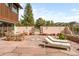 Inviting patio with lounge chairs, a dining table and chairs set against a natural, wooded backdrop at 393 Dixon Rd, Boulder, CO 80302