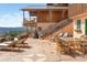 Stone patio with sun loungers, dining table, and mountain views at 393 Dixon Rd, Boulder, CO 80302