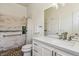 Bathroom featuring a tiled shower with a glass door and a vanity with solid surface countertops at 13668 Plaster Cir, Broomfield, CO 80023