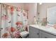 Cozy bathroom with floral accents and a neutral-toned vanity at 13668 Plaster Cir, Broomfield, CO 80023
