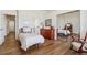 Bedroom featuring hardwood floors, a mirrored closet, and an en-suite bathroom at 13668 Plaster Cir, Broomfield, CO 80023