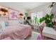 Bright bedroom with a pink-themed décor, adorned with plants and natural light at 13668 Plaster Cir, Broomfield, CO 80023
