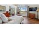 Bedroom with a large window offering a beautiful view, hardwood floors, and ample natural light at 13668 Plaster Cir, Broomfield, CO 80023