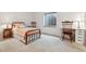Cozy bedroom featuring a metal bed frame, neutral carpet, and natural light from a window at 13668 Plaster Cir, Broomfield, CO 80023