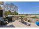 Deck area featuring a grill, table, chairs, and a view of the green space and lake at 13668 Plaster Cir, Broomfield, CO 80023