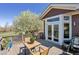 Spacious outdoor deck with seating and a view of the blooming backyard tree at 13668 Plaster Cir, Broomfield, CO 80023