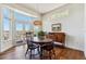 Dining area with a round table, bay window, and access to the deck at 13668 Plaster Cir, Broomfield, CO 80023