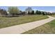 Beautiful home with a green grassy lawn, a sidewalk, mature trees and a white fence at 13668 Plaster Cir, Broomfield, CO 80023