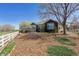 Backyard with native landscaping surrounding a well-maintained brown-sided home at 13668 Plaster Cir, Broomfield, CO 80023