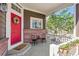 Cozy front porch features a red door, welcome mat, and seating for relaxing outdoors at 13668 Plaster Cir, Broomfield, CO 80023