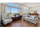 Comfortable living room features large windows, hardwood floors, and lake views at 13668 Plaster Cir, Broomfield, CO 80023