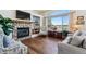 Welcoming living room with a stone fireplace, hardwood floors, and lake views at 13668 Plaster Cir, Broomfield, CO 80023