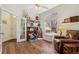 Sunlit office featuring hardwood floors, built-in shelving and a large window at 13668 Plaster Cir, Broomfield, CO 80023