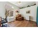 Bright office space with hardwood floors, a large window and cozy chair at 13668 Plaster Cir, Broomfield, CO 80023