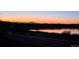 Peaceful sunset view of a lake with mountain backdrop along a paved path at 13668 Plaster Cir, Broomfield, CO 80023
