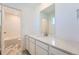 Bright bathroom featuring a white vanity with a quartz countertop, undermount sink, and a view of the tiled shower at 10984 Snowdon St, Parker, CO 80134