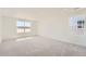 Bright and spacious bedroom featuring large windows with views and plush carpeting at 10984 Snowdon St, Parker, CO 80134
