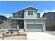Charming two-story home with a two-car garage, stone accents, and a covered front porch at 10984 Snowdon St, Parker, CO 80134