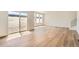Sun-filled living area showcases an open layout, a large sliding glass door, and hardwood floors at 10984 Snowdon St, Parker, CO 80134