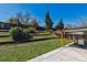 Expansive backyard with tiered landscaping, a lawn, and covered patio at 13472 W Dakota Ave, Lakewood, CO 80228