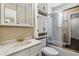Bathroom with a marble vanity, white cabinets, and shower/tub with glass doors at 13472 W Dakota Ave, Lakewood, CO 80228
