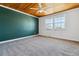 Bright bedroom featuring wood-paneled ceilings, a green accent wall, and large windows at 13472 W Dakota Ave, Lakewood, CO 80228