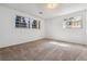 Empty bedroom with carpet, three windows and light-colored walls at 13472 W Dakota Ave, Lakewood, CO 80228