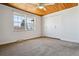 Well-lit bedroom featuring wood-paneled ceilings, a ceiling fan and spacious closet at 13472 W Dakota Ave, Lakewood, CO 80228