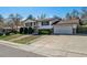 Charming two-story home with landscaped front yard and attached two-car garage on a sunny day at 13472 W Dakota Ave, Lakewood, CO 80228