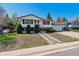Charming two-story home with landscaped front yard and attached two-car garage on a sunny day at 13472 W Dakota Ave, Lakewood, CO 80228