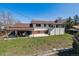 Exterior of the home showcasing the backyard and covered patio area at 13472 W Dakota Ave, Lakewood, CO 80228