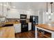 The kitchen features white cabinets, black appliances, butcher block countertops, and brick backsplash at 13472 W Dakota Ave, Lakewood, CO 80228