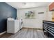 Bright laundry room with new washer, dryer, and built-in tool chest at 13472 W Dakota Ave, Lakewood, CO 80228