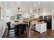 This open concept living area features a combined kitchen, dining area, and seating area, all with wood floors at 13472 W Dakota Ave, Lakewood, CO 80228