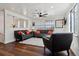 Bright living room with hardwood floors, modern ceiling fan, and two large windows for natural light at 13472 W Dakota Ave, Lakewood, CO 80228